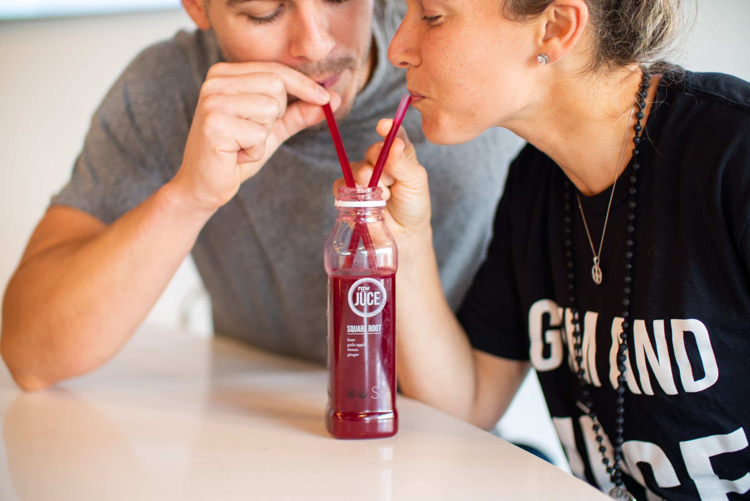 2 people sipping on raw juice