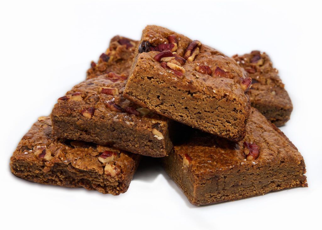 A golden pecan-studded blondie brownie with a soft caramelized texture.