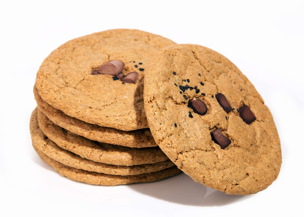 A stack of golden chocolate chip cookies with visible chunks of chocolate.