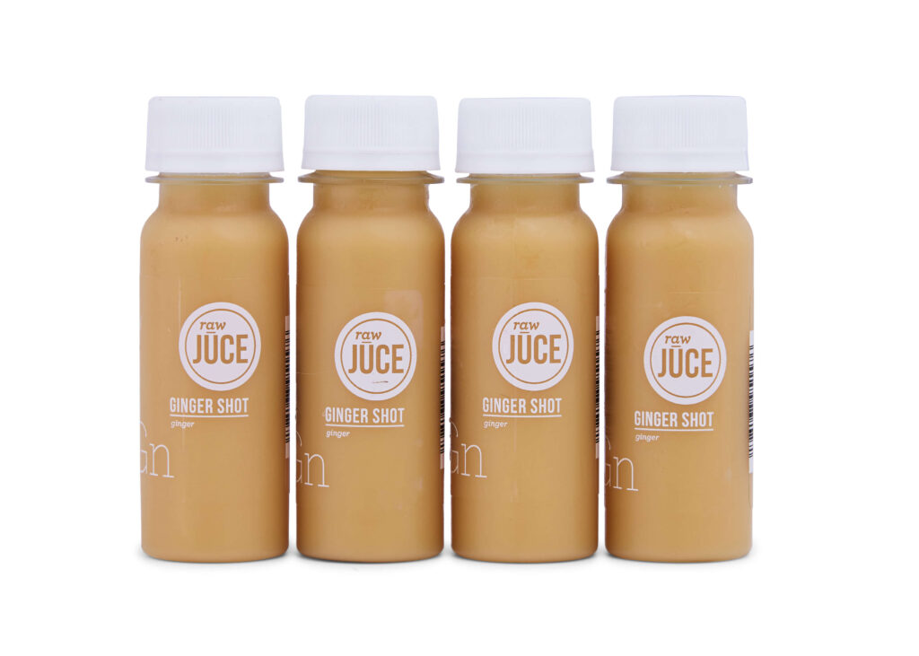 A set of four cold-pressed ginger and lemon shots.