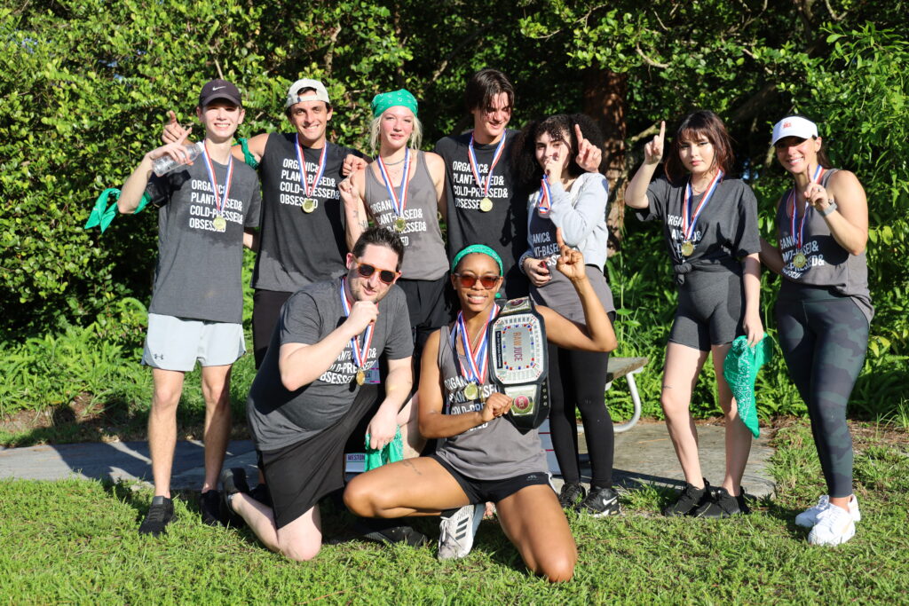 Raw Juce Team Members with championship belt