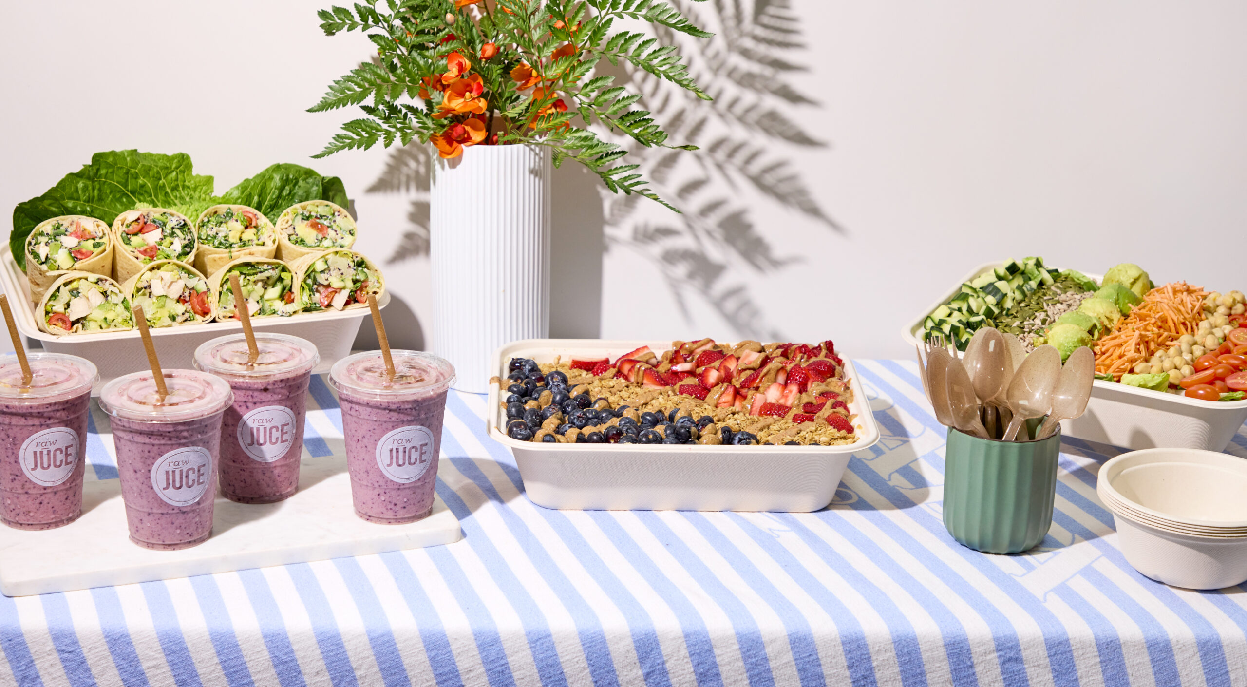 Raw Juce catering with acai catering trays, organic smoothies, wraps, and salad